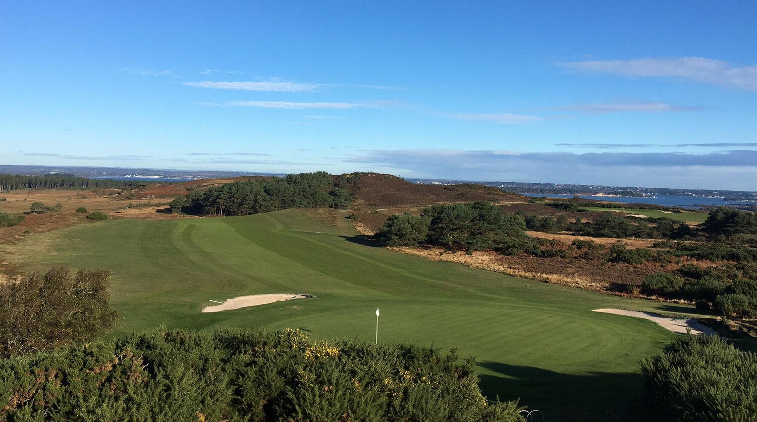 Wide fairway leading to smooth green with white flagstick