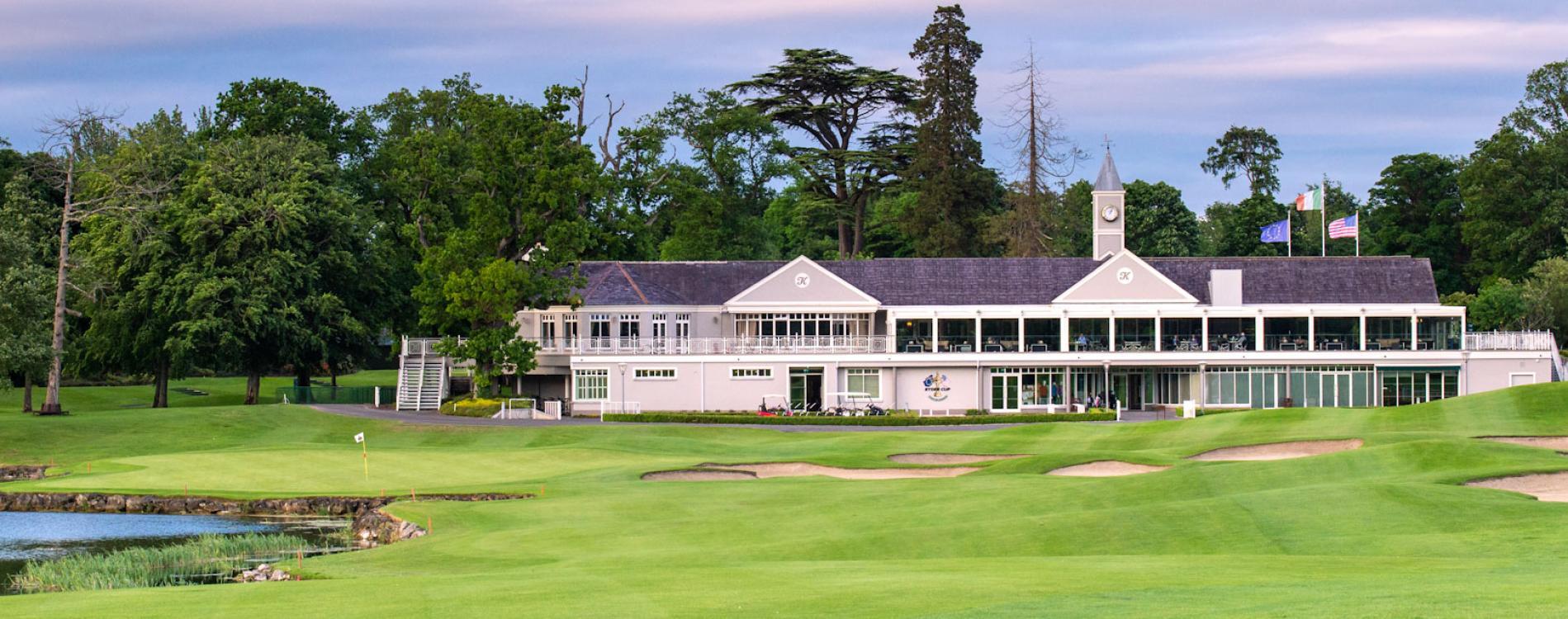 The clubhouse sits proudly amidst perfectly manicured greens and bunkers.