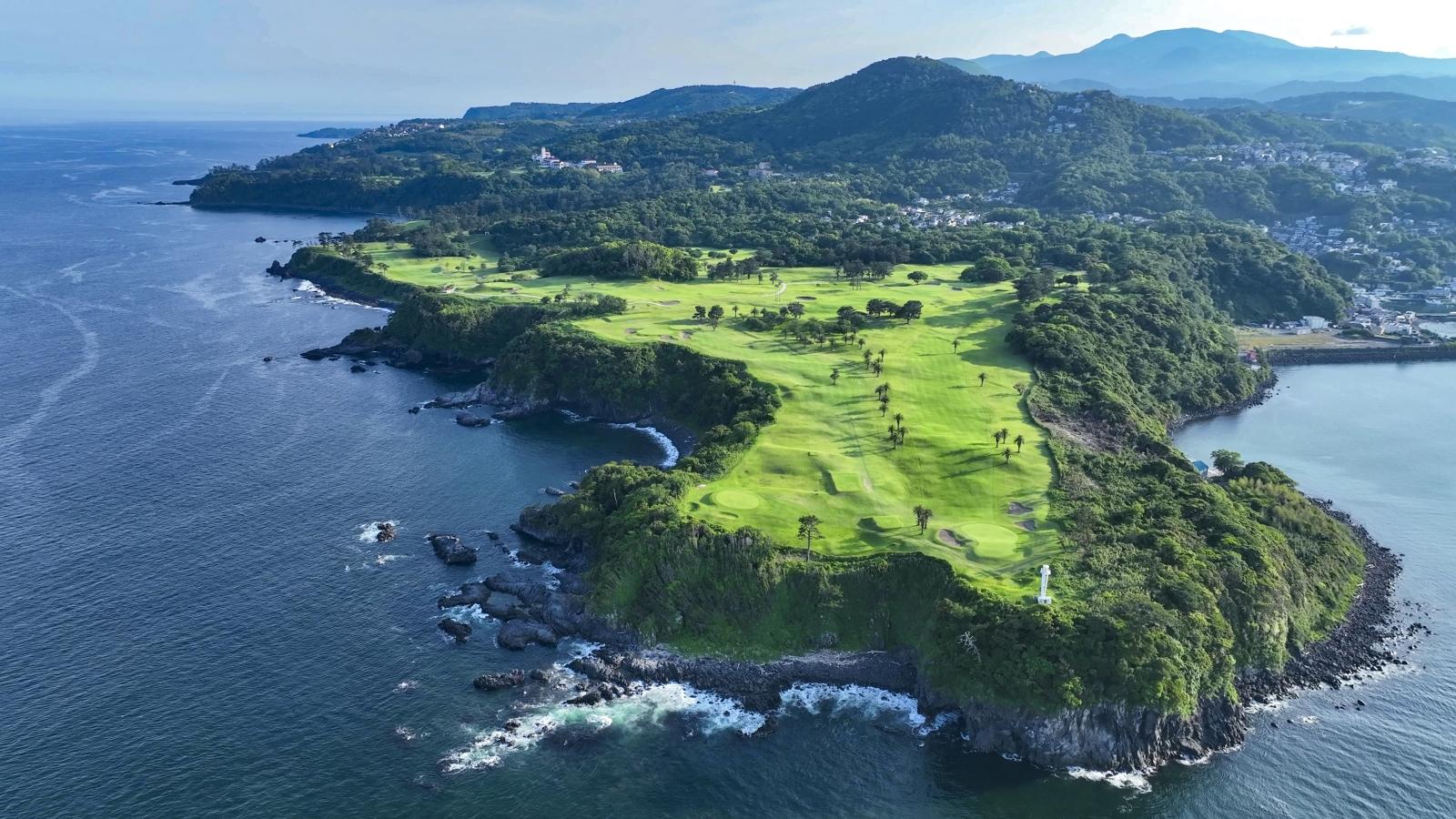 Aerial view of the Fuji Course running along a rugged coastline.
