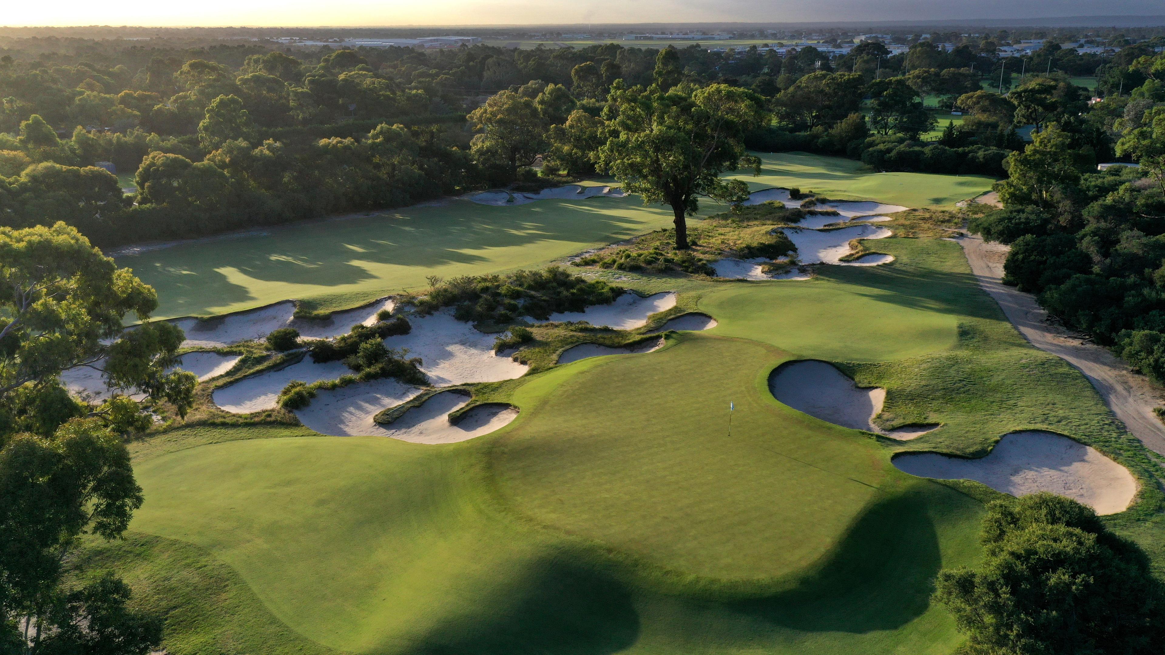 Overhead view of a smooth green surrounded by sand bunkers