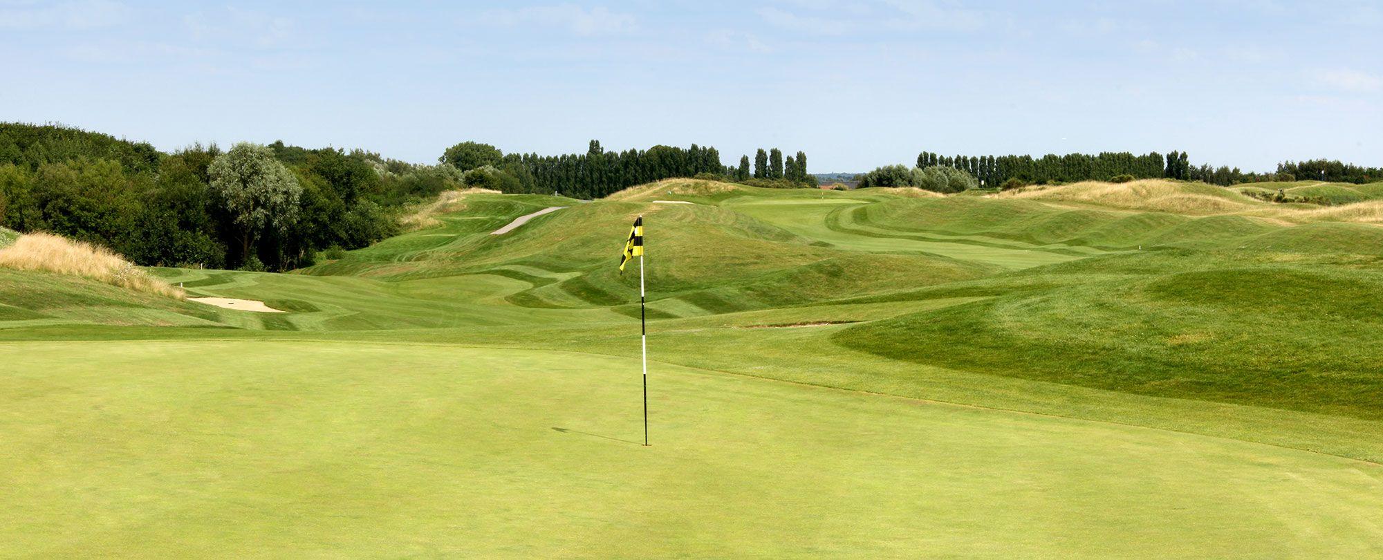 Narrow, winding fairway leading to the green