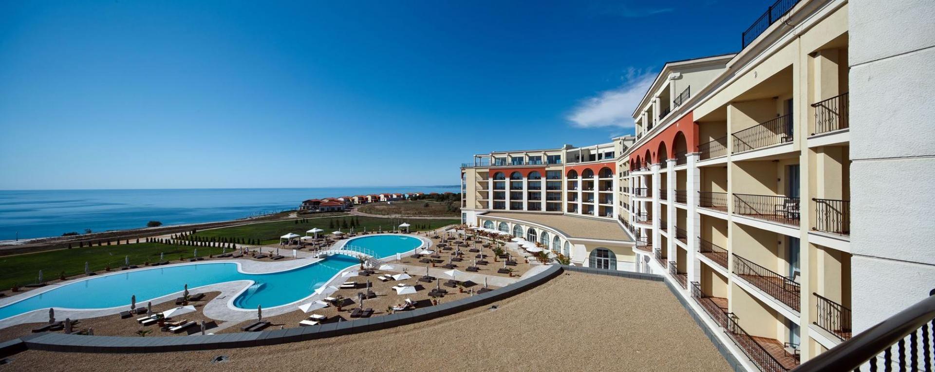Panoramic view of the Lighthouse Golf & Spa Resort building looking over their swimming pool