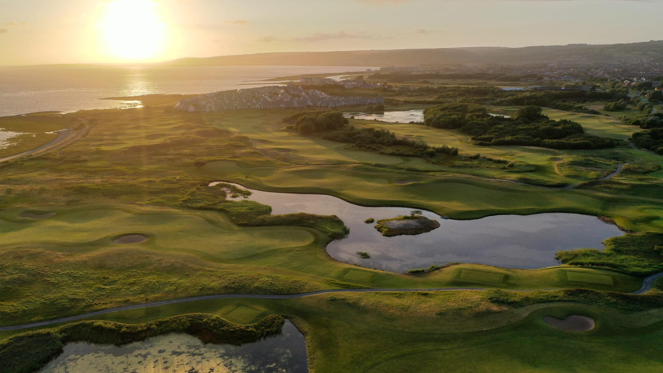Machynya Peninsula course featuring water hazards and expansive, manicured greens.
