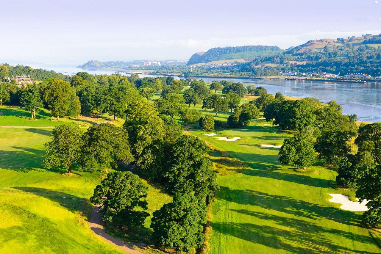 Wide fairway, sand bunkers and towering trees running down the coast