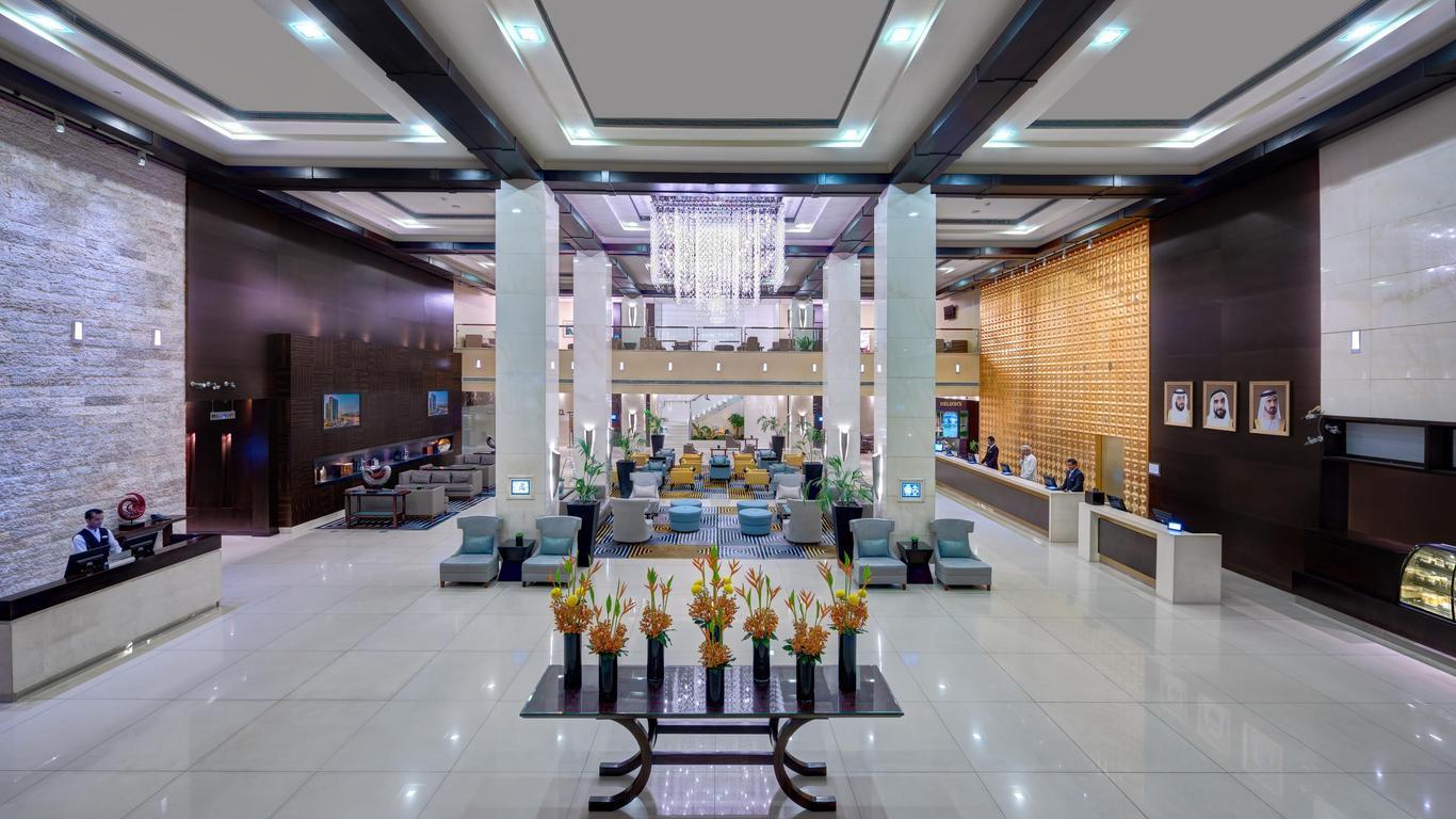 An luxurious reception at the hotel with a grand chandler hanging over a lounging area