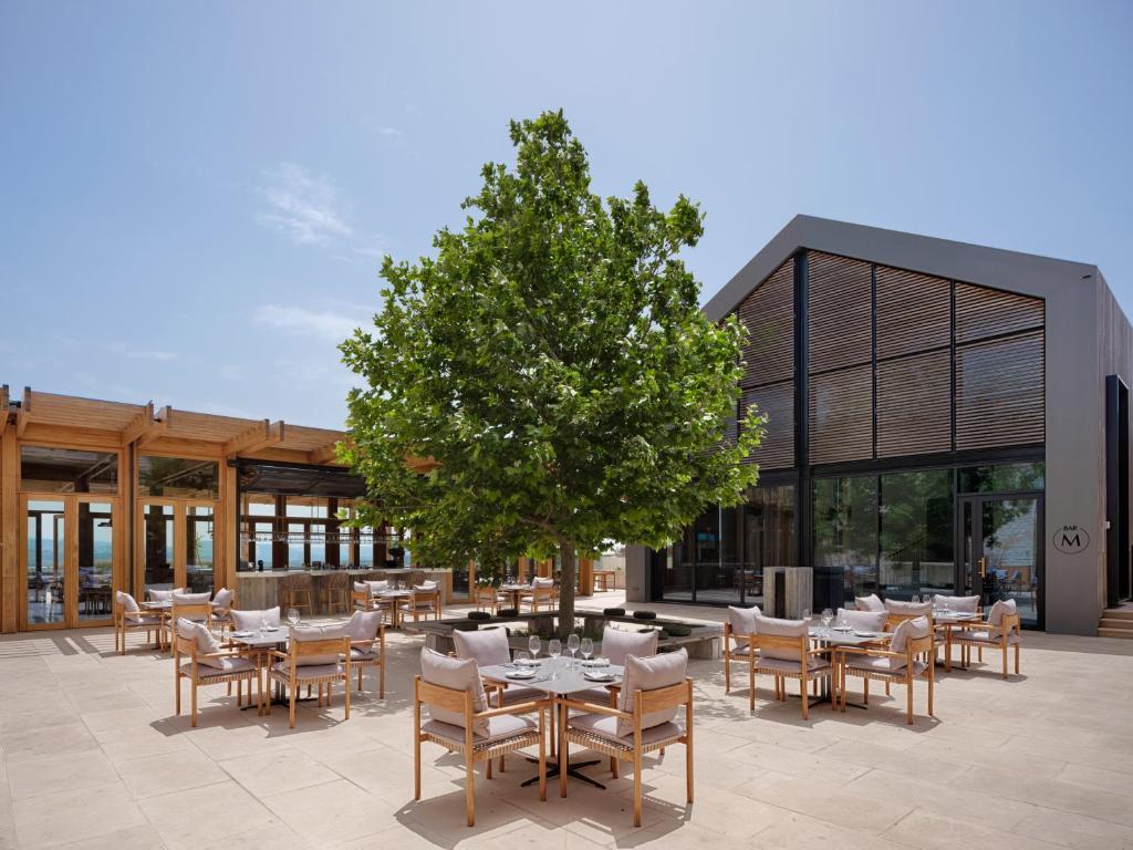 Outdoor seating area at the Minthis Resort featuring a tree in the centre