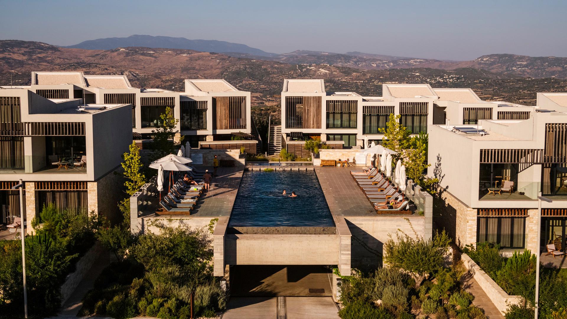 Overhead view of an elevated swimming pool between the resorts hotel rooms