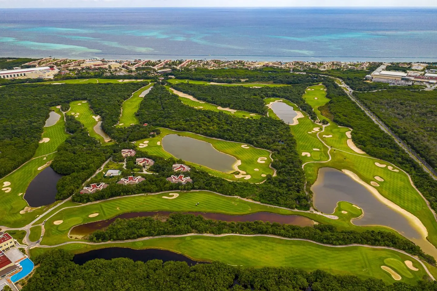 Expansive layout of the golf course with winding fairways and multiple water hazards.