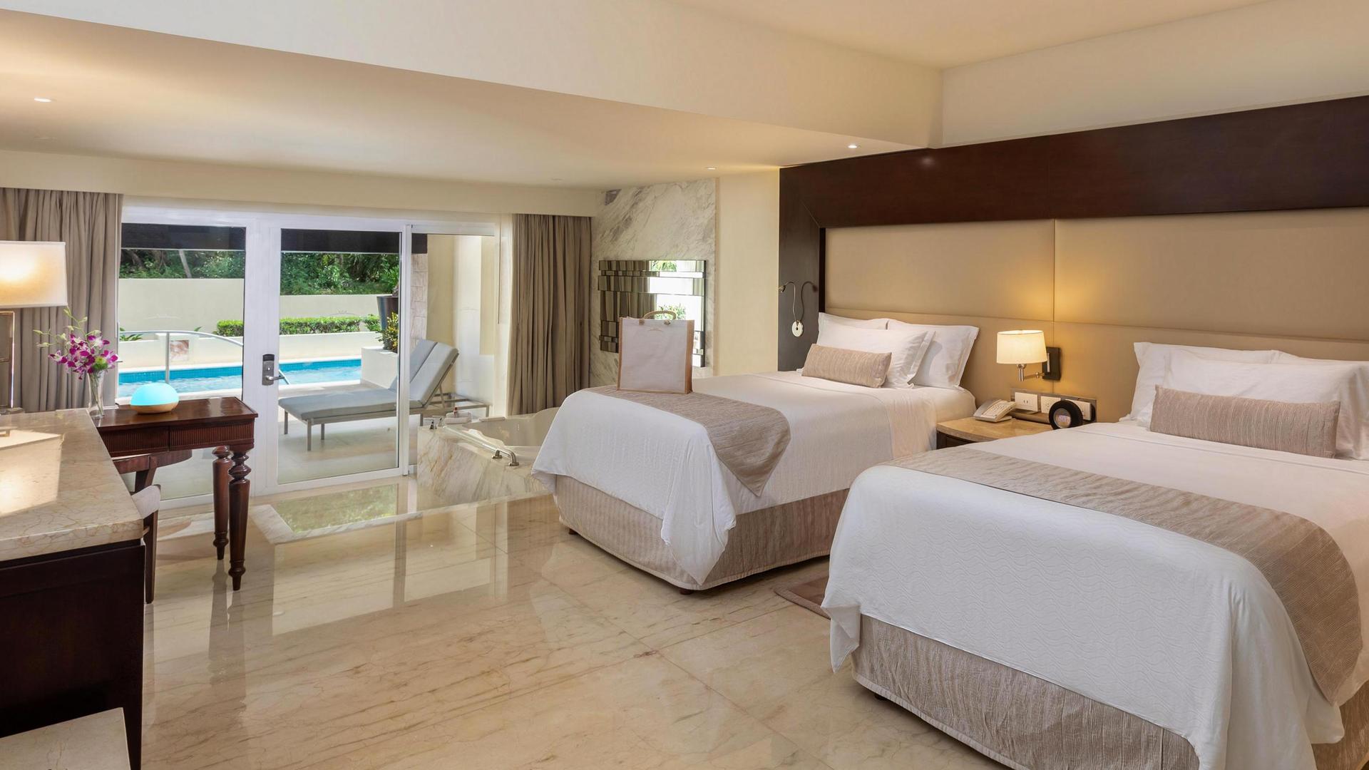 Modern twin double bed room at the resort following a cream theme with a personal pool