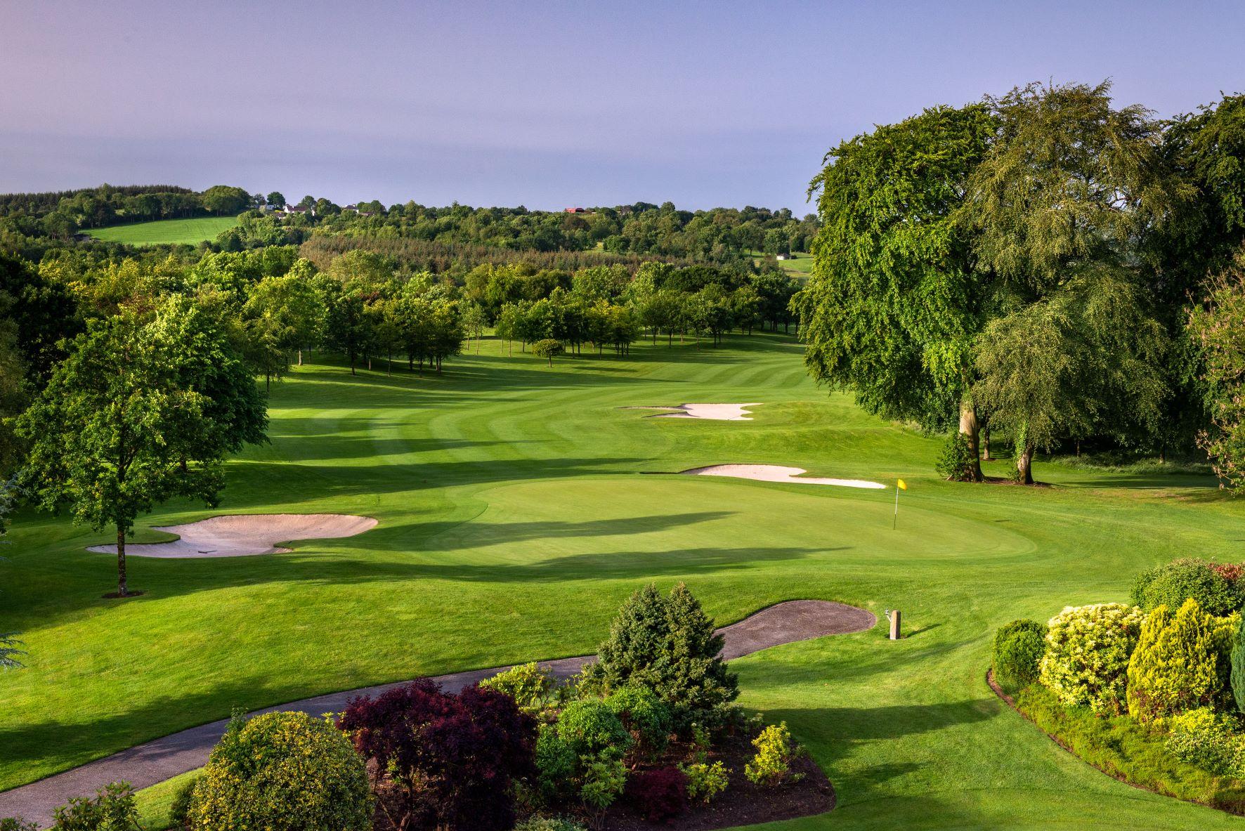 Wide angle shot of the greens at the PGA National course with wide fairways and well-kept grass