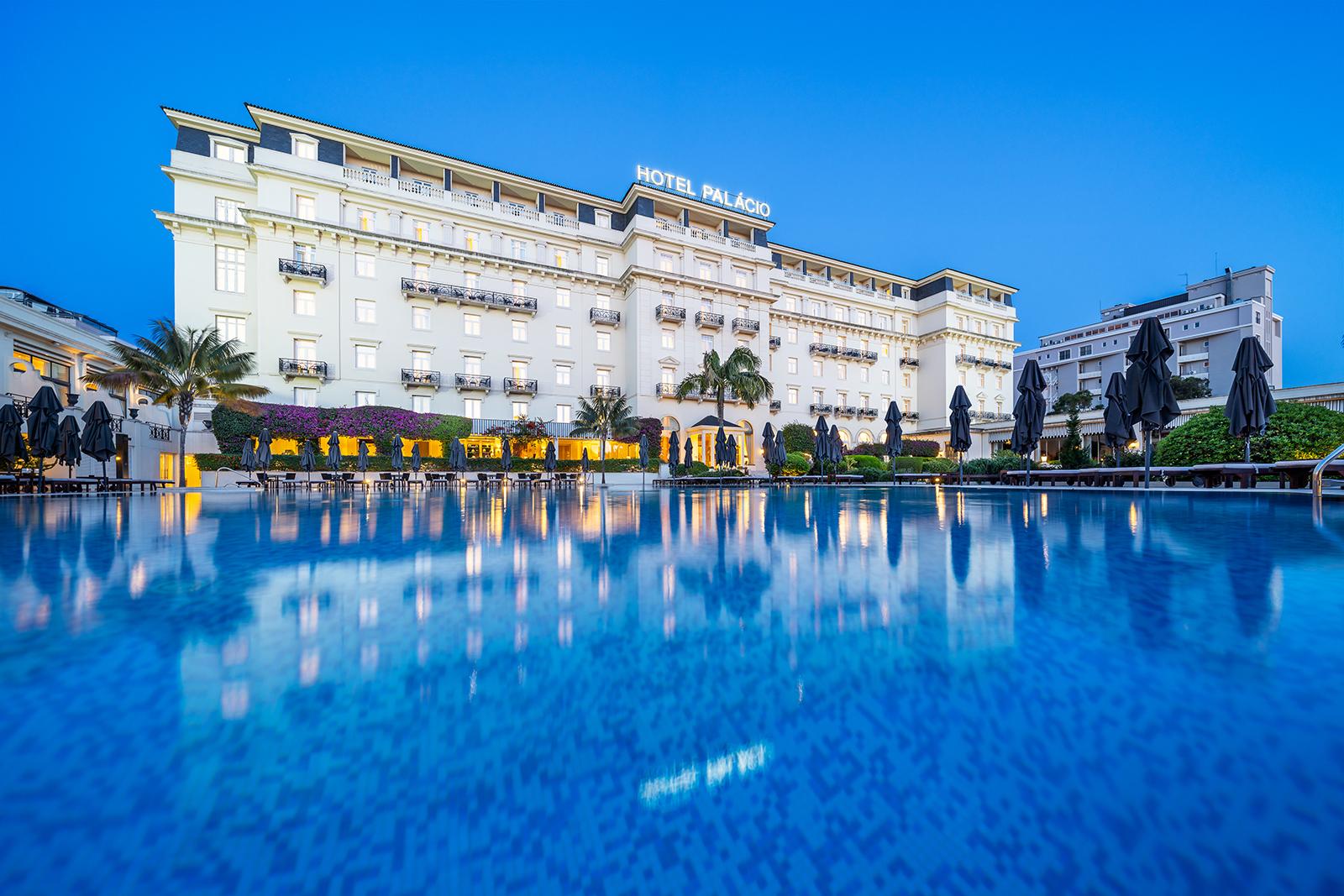 Outdoor swimming pool area with the Hotel Palacio Estoril in the background