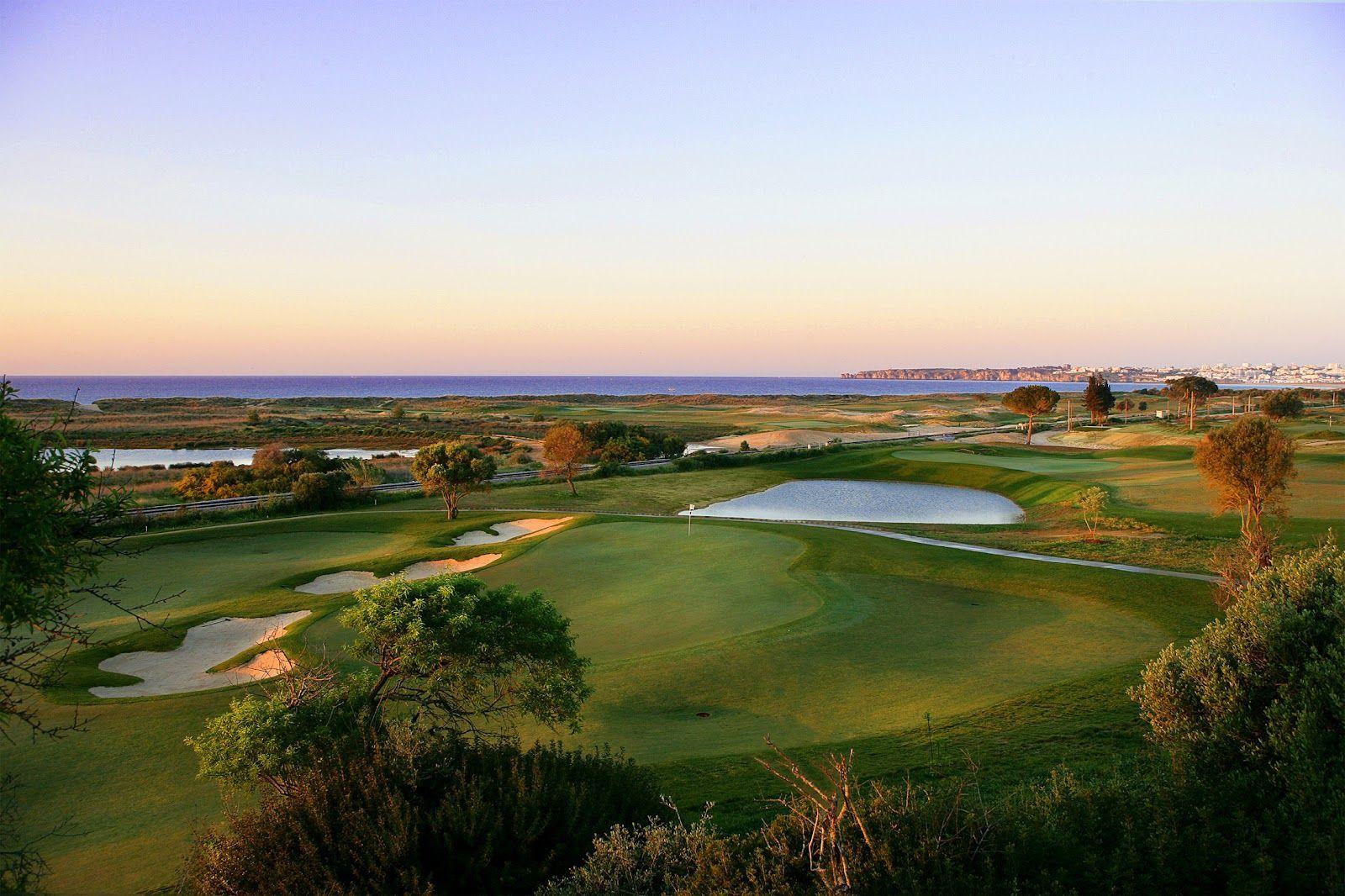 Undulating green with bunkers around and water behind