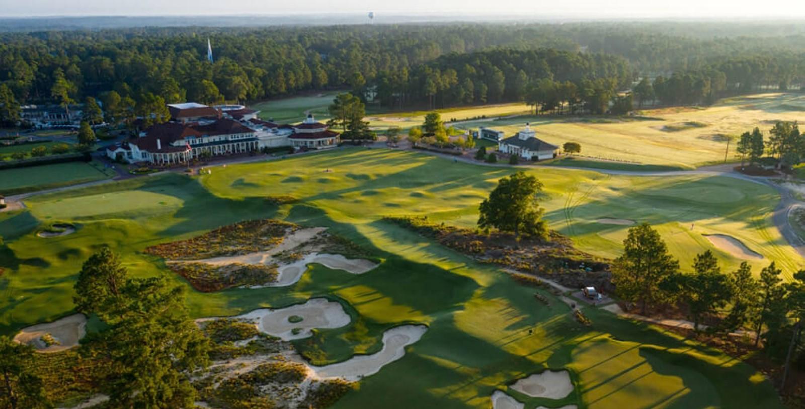Aerial view of Pinehurst resorts clubhouse overlooking the course riddles with sand bunkers and rolling dunes