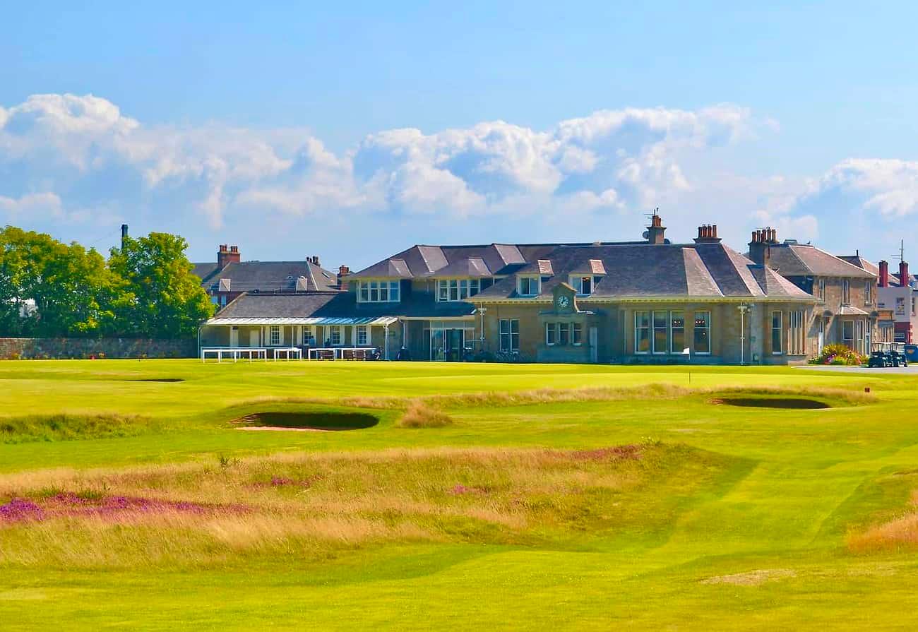 The lush, rolling fairways with the historic clubhouse in the background.