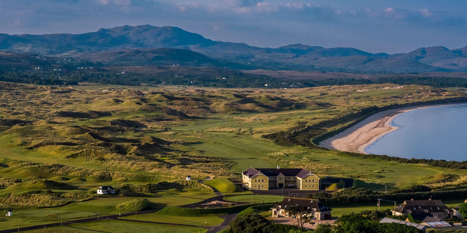 Elevated shot of the resort and course in the background just next to a beach which spans down the coastline