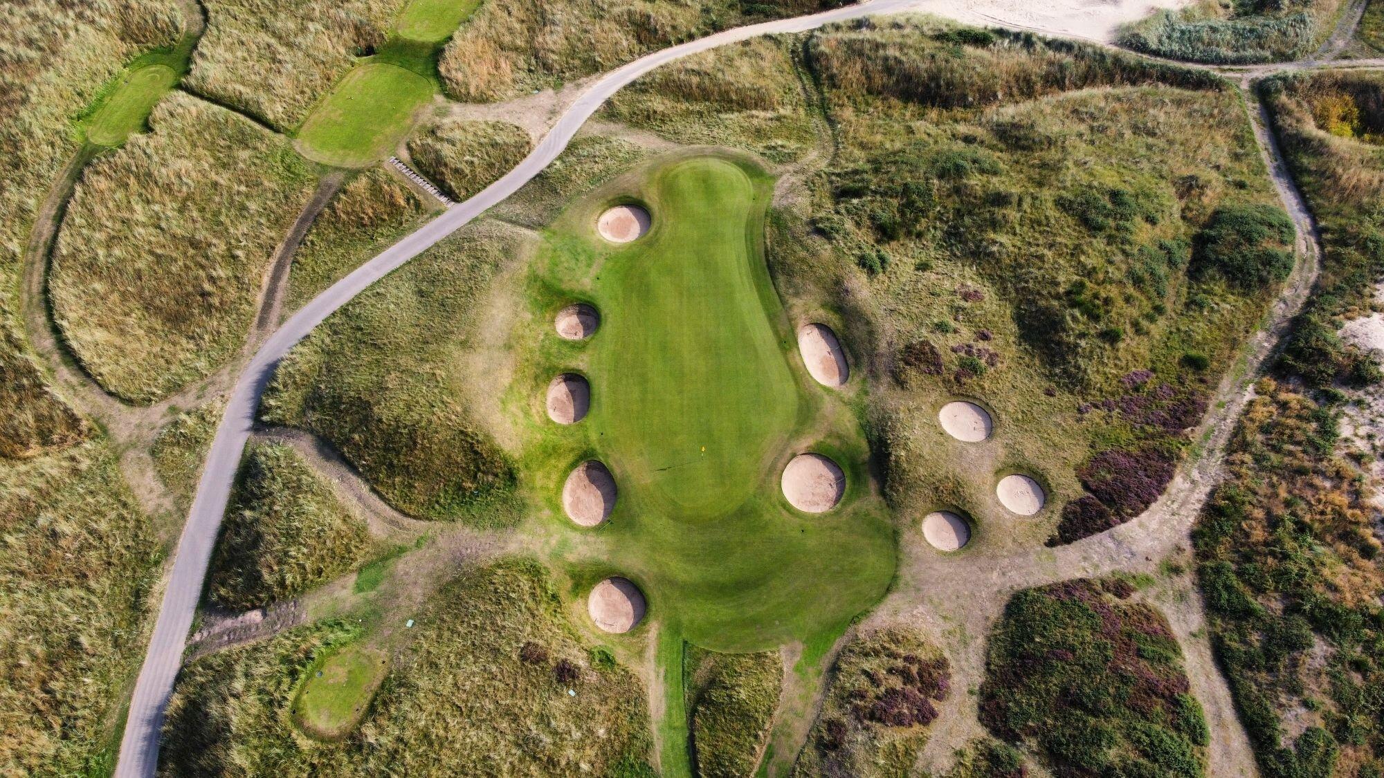 Aerial view of the green nestled with multiple sand bunkers