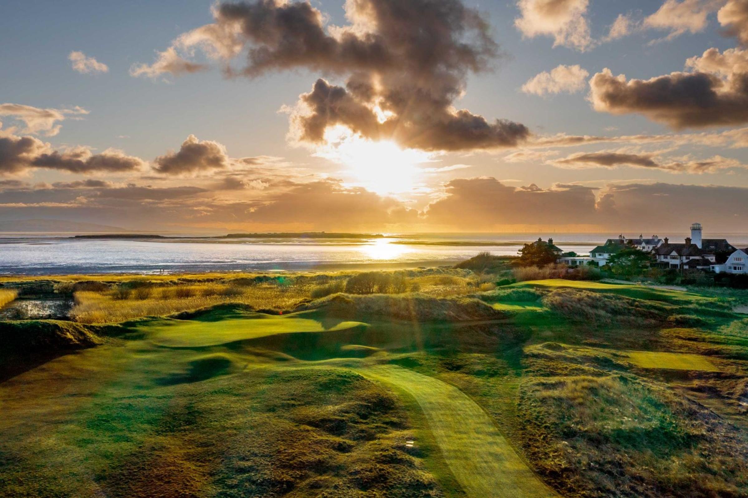 Panoramic view of the golden sun shining down onto the course causing the rolling dunes to shadow