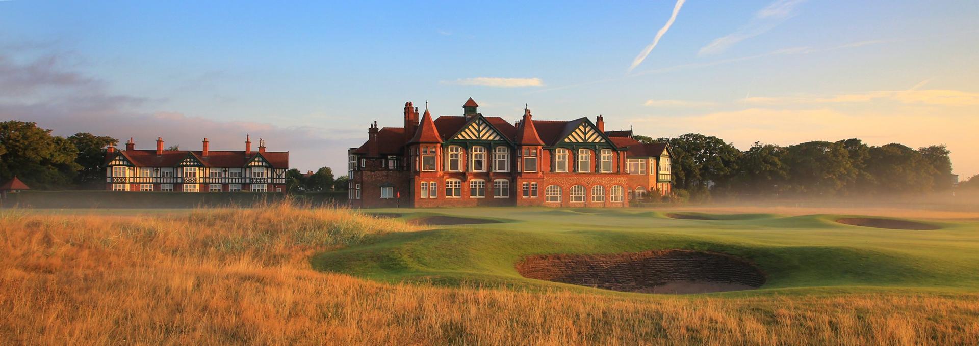 The Royal Lytham & St Anne's clubhouse under blue skies looking onto the golden rough and deep sand bunkers on the course.