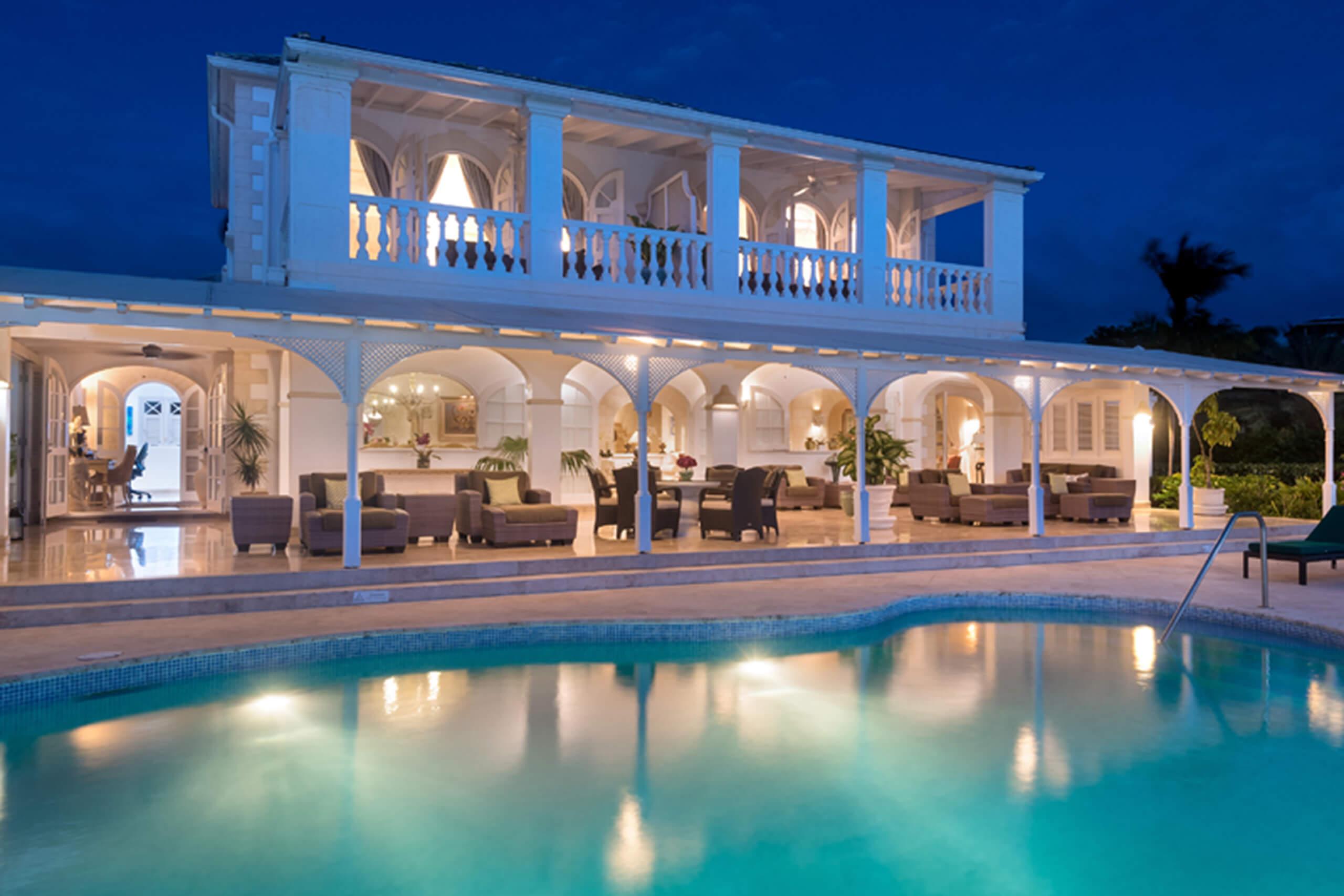 A guest house at the resort under evening skies being lit up by the buildings lights