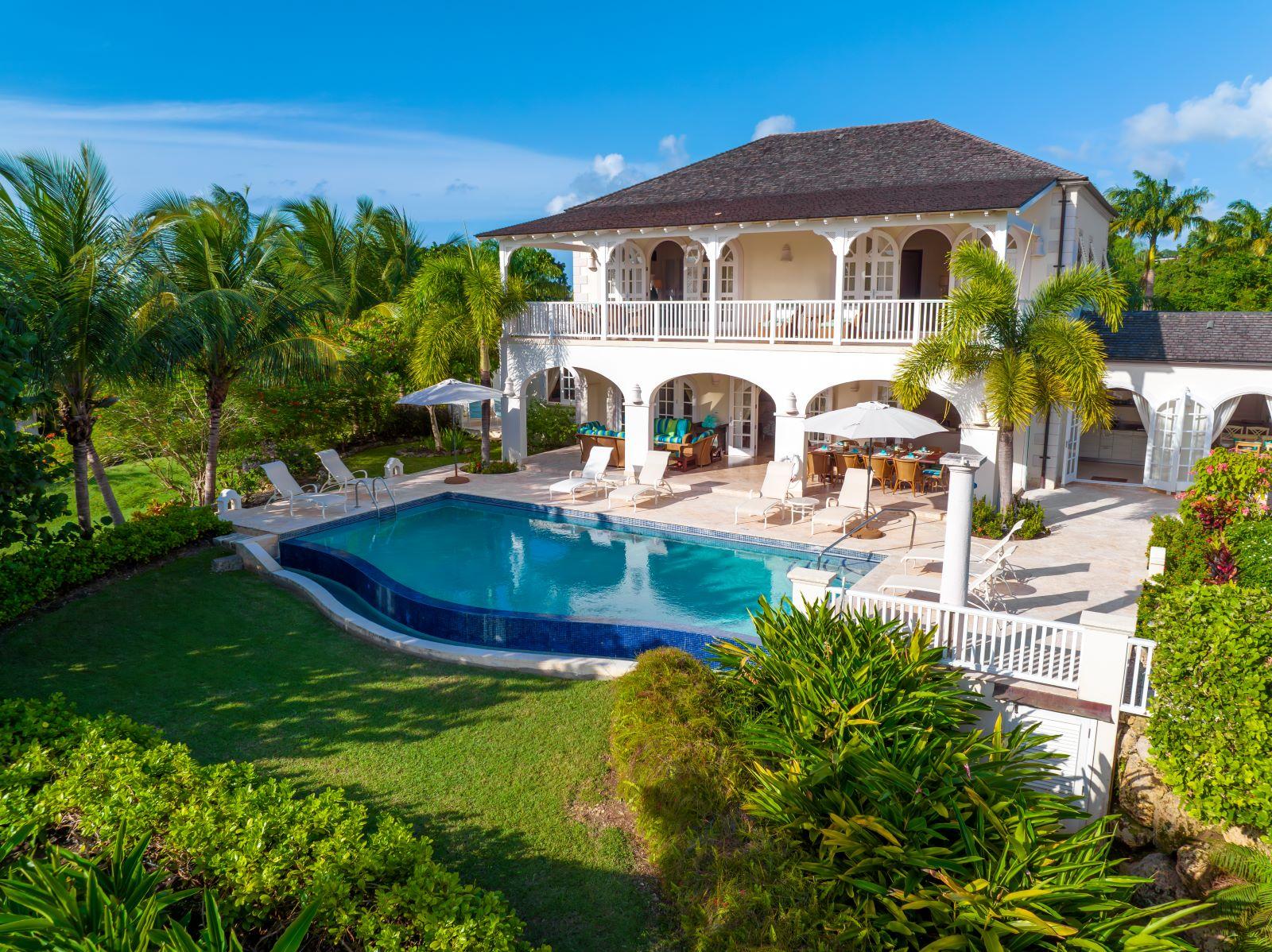 A guest house at the resort featuring a personal swimming pool surrounded by palm trees