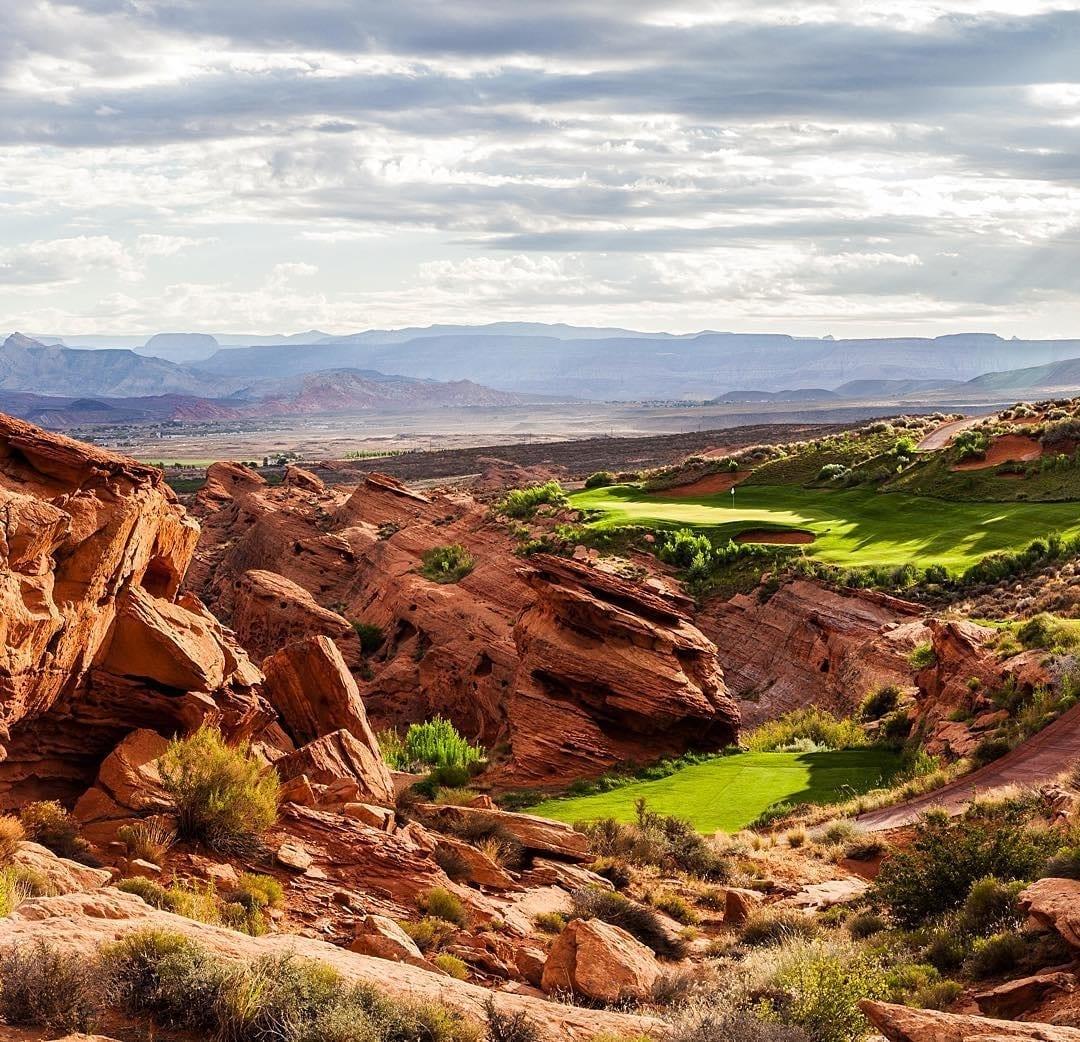 The course blends seamlessly into jagged rocky terrain and desert landscape.