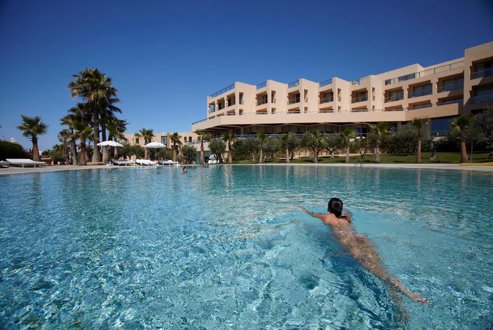 Guest swimming in one of the outdoor swimming pools