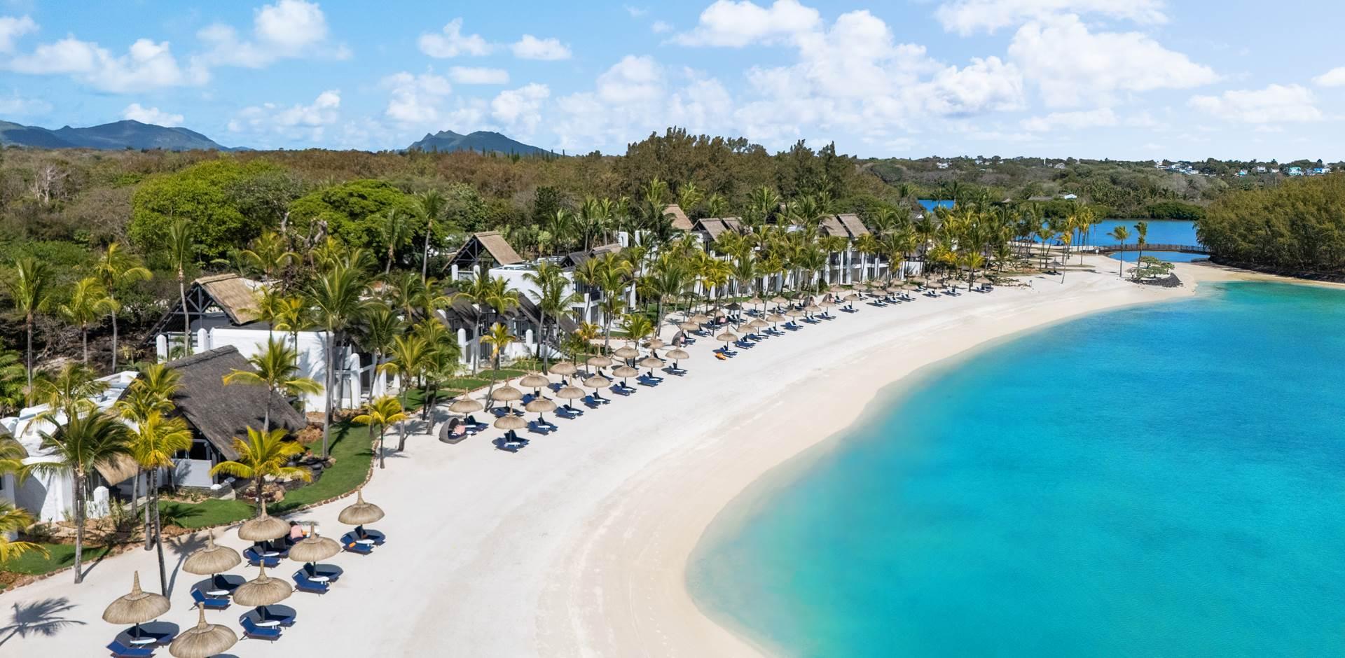 The Shangri-La Le Touessrok Mauritius private beach littered with sunbeds and umbrellas