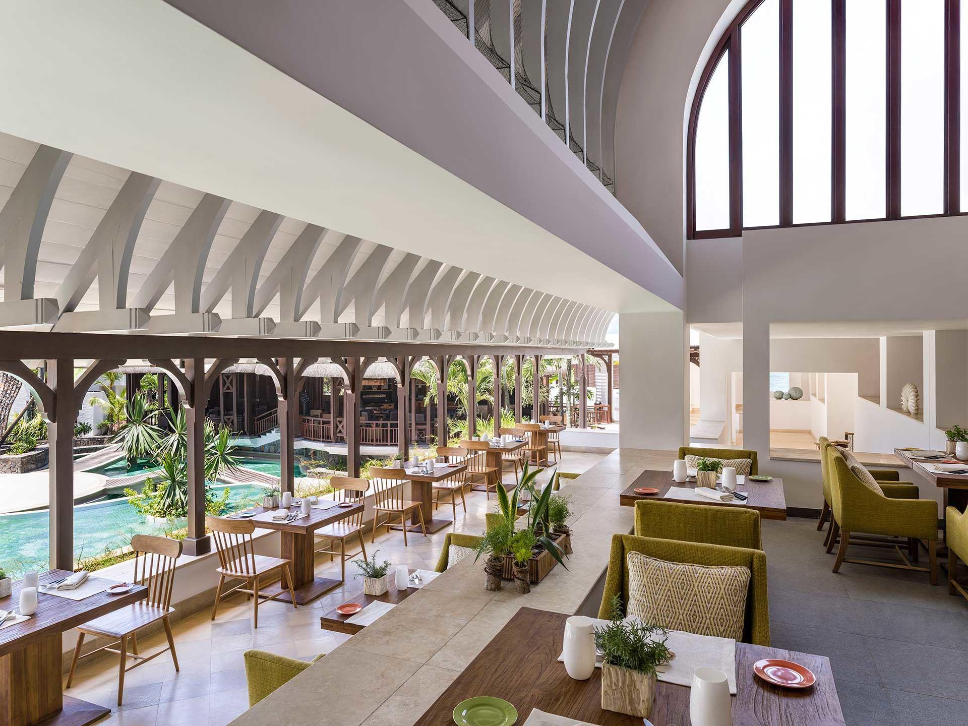 Dining area at the Shangri-La Le Touessrok Mauritius with balcony views of the outdoor swimming pool