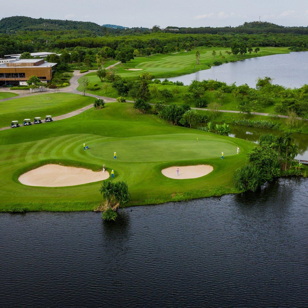Overhead view of golfers enjoying their round on a smooth green surrounded by sand bunkers