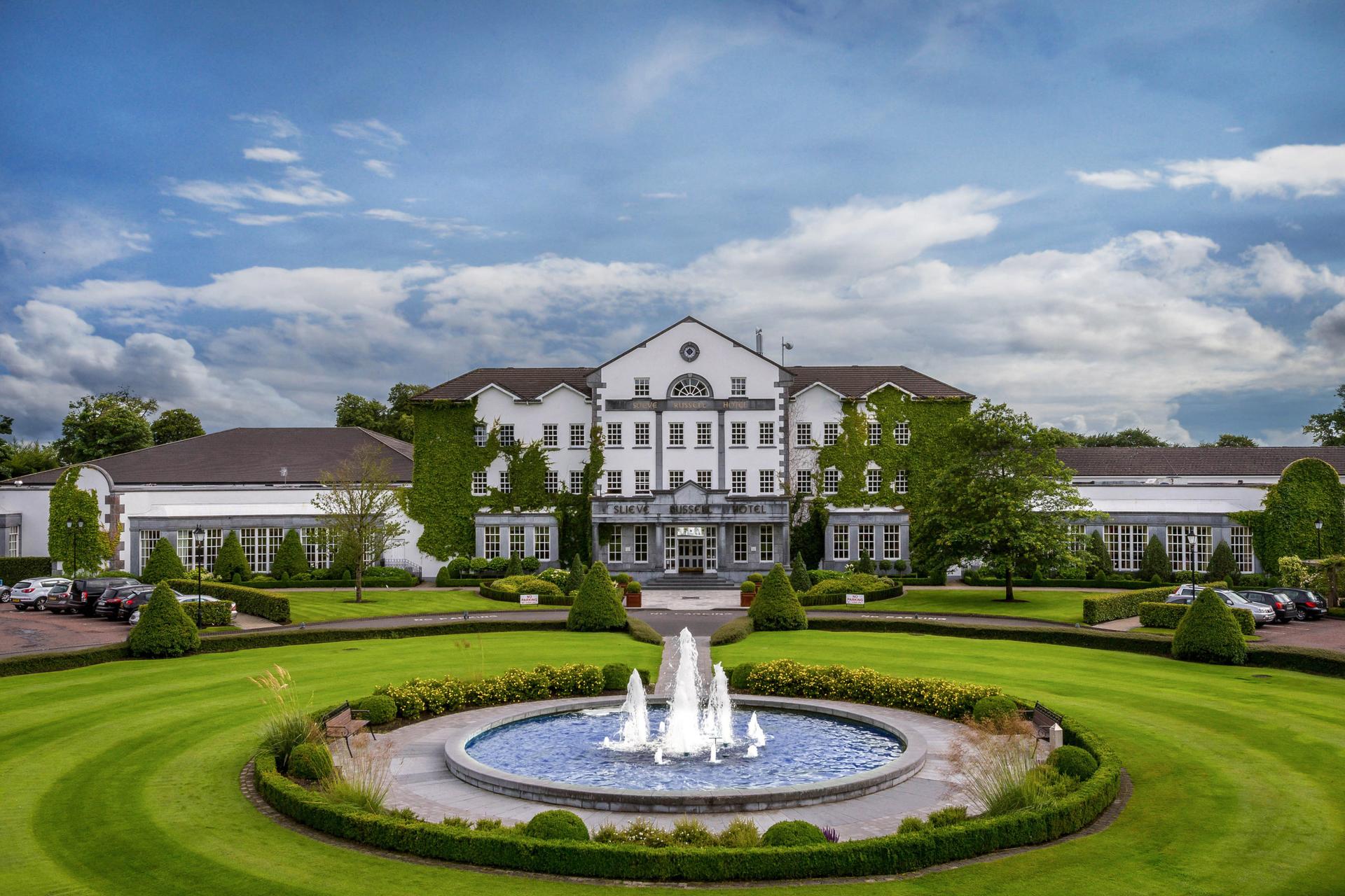 Front of the building at Slieve Russell with a beautiful water fountain and rich greenery surrounding the building