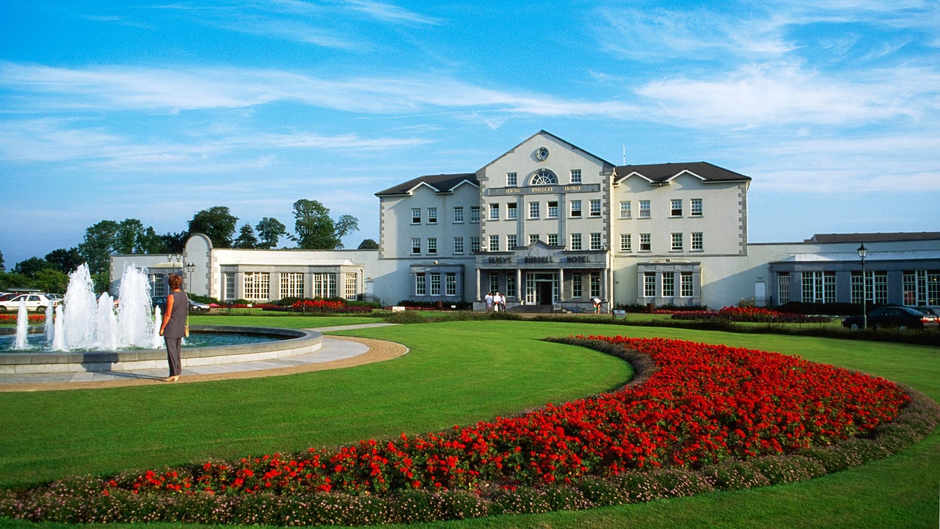 Vibrant colour from the roses next to the water fountain at the front of house