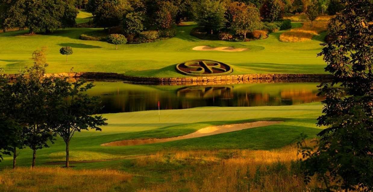Lovely view of the greens with a grass sculpture that reads SR for Slieve Russell just behind to a body of water