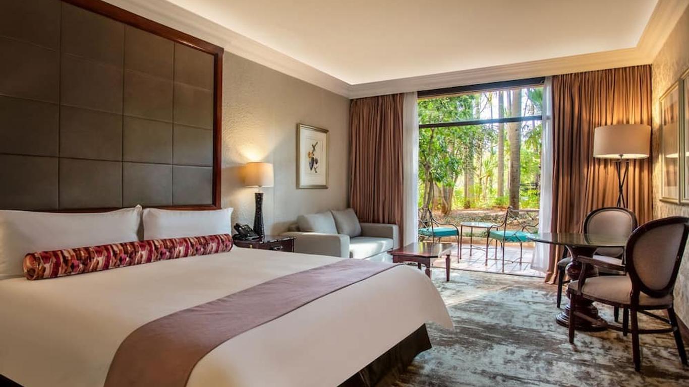 Double bed suite at the hotel with patio seating and views of the forest