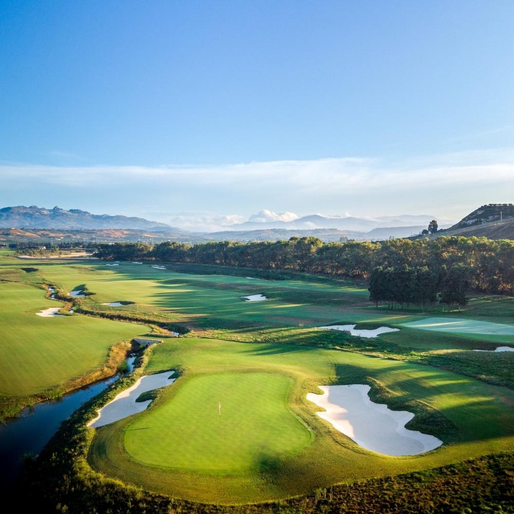 Overhead view of a smooth green surrounded by sand bunkers