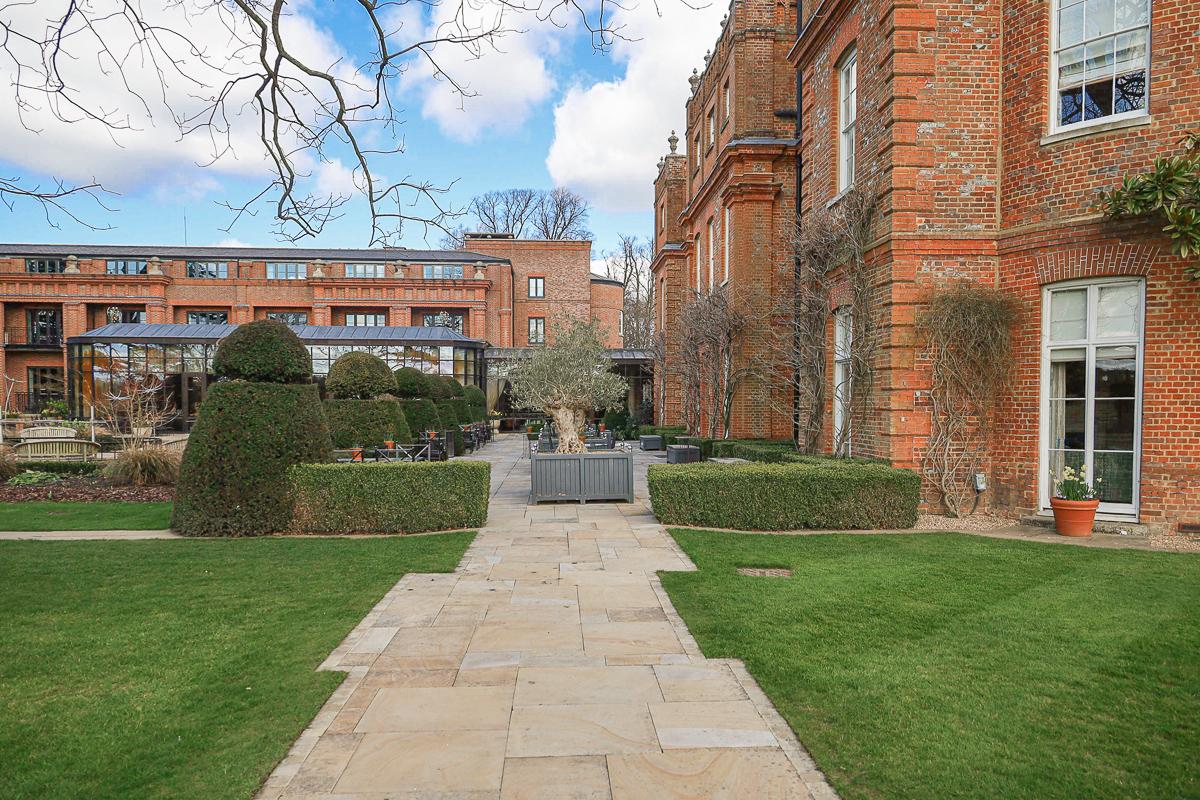 Outdoor seating area just beside The Grove building with controlled roots growing