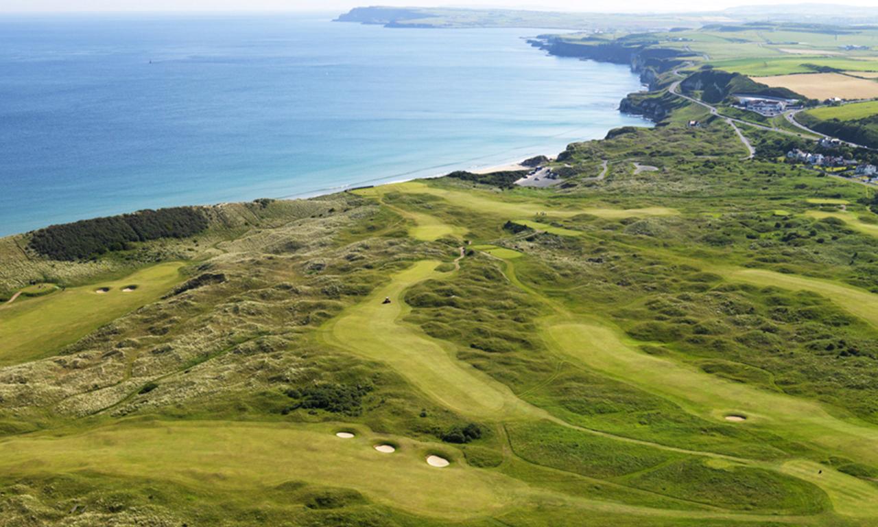 A stunning cliffside golf course with fairways running parallel to the coastline, offering breathtaking views of the ocean and rocky shores.
