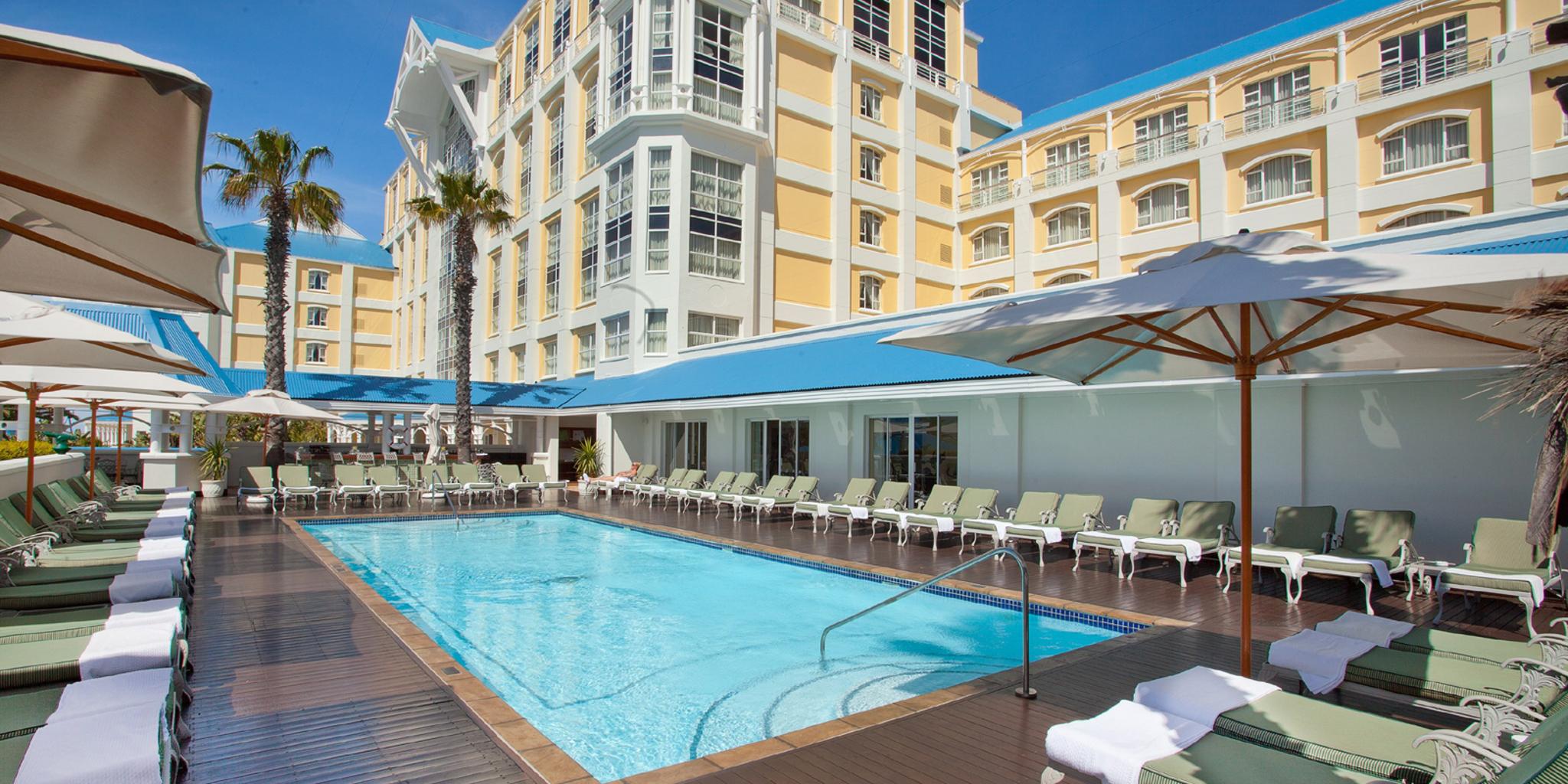 Outdoor swimming pool at The Table Bay Hotel surrounded by sunbeds