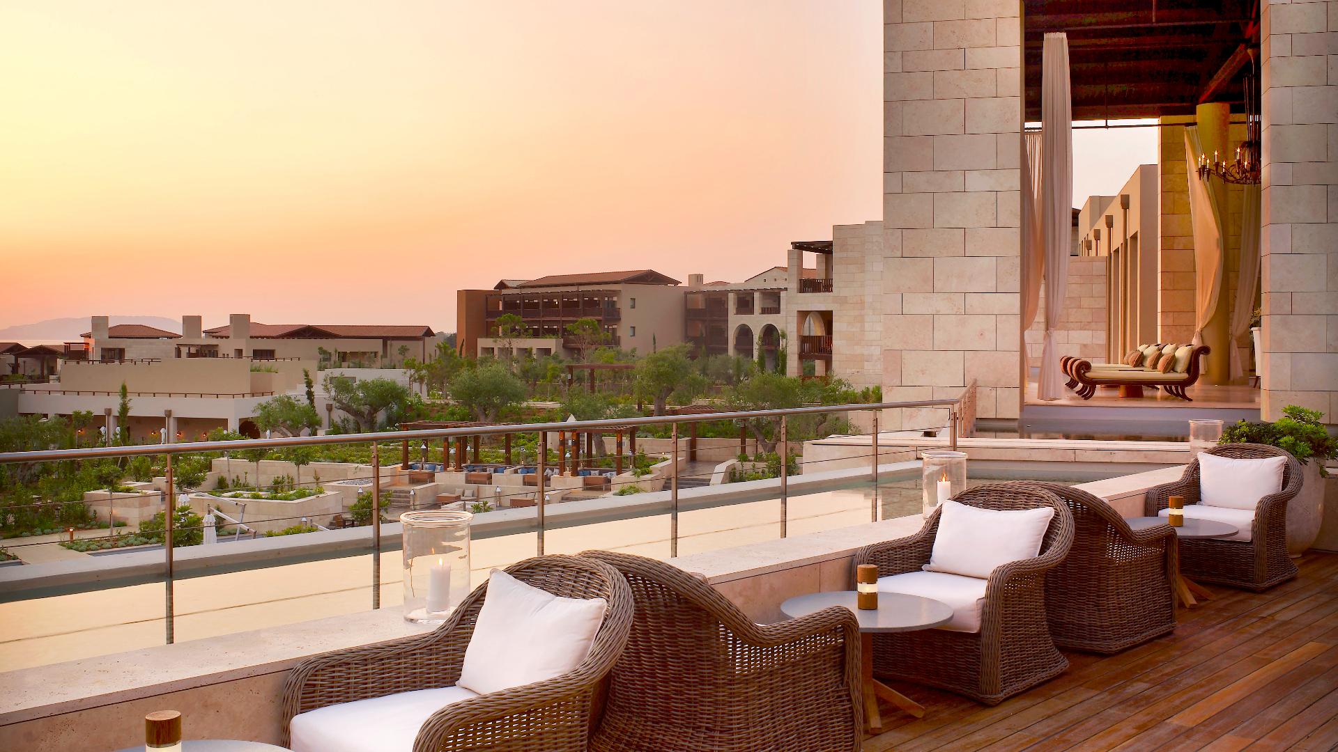 Outdoor seating at the resort with the sun setting