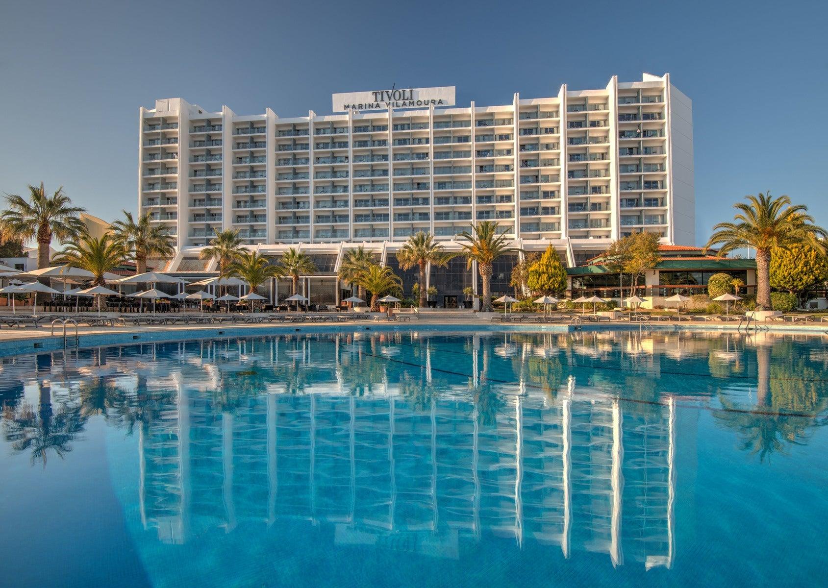 Outdoor swimming pool area with the hotel in the background