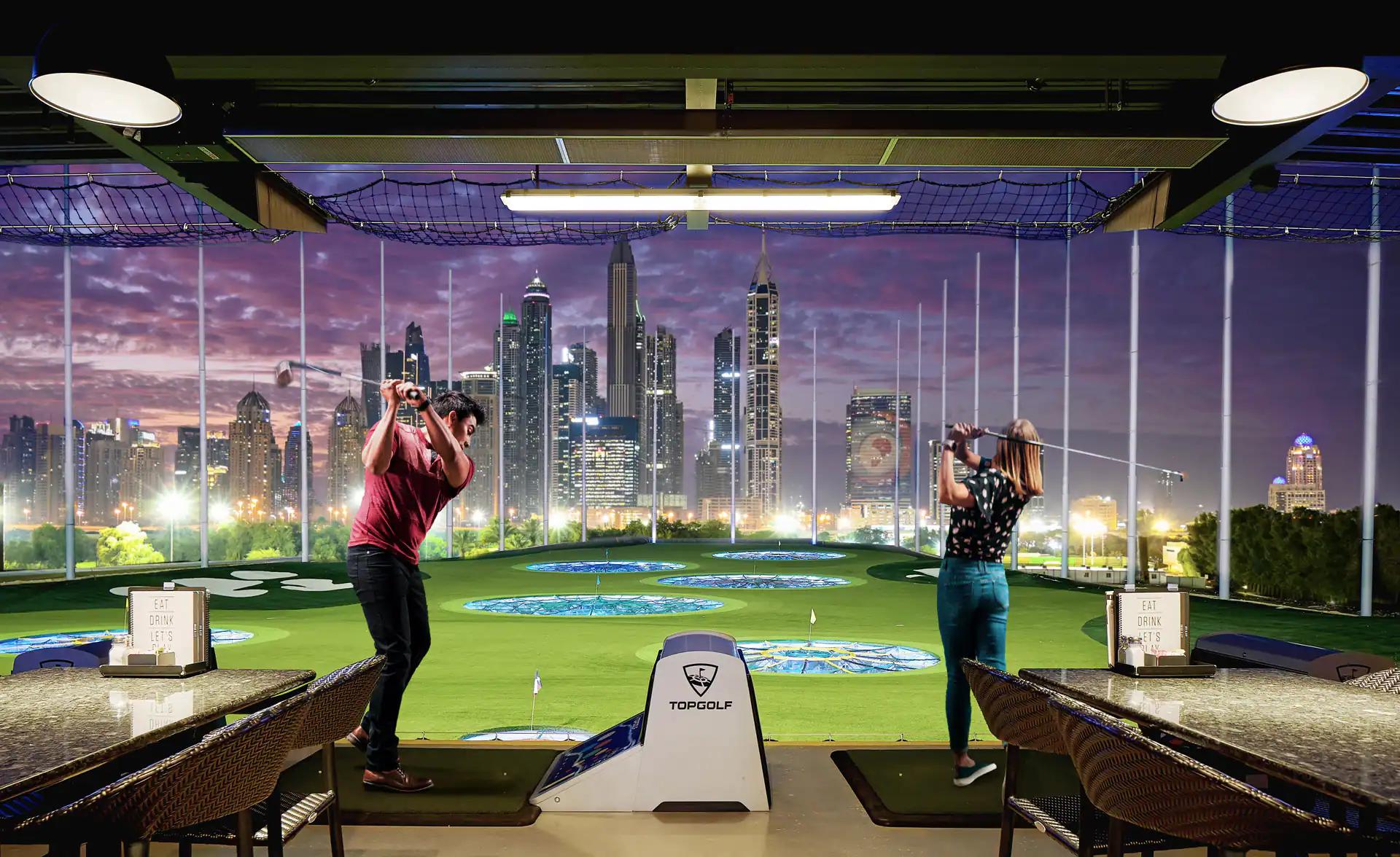 Indoor golf simulator with Dubai skyline on screens