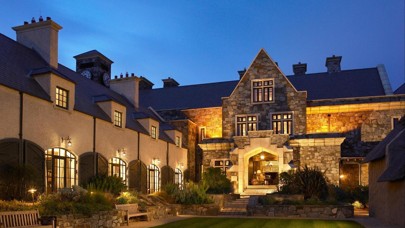 The grand stone façade of Trump Doonbeg at dusk.