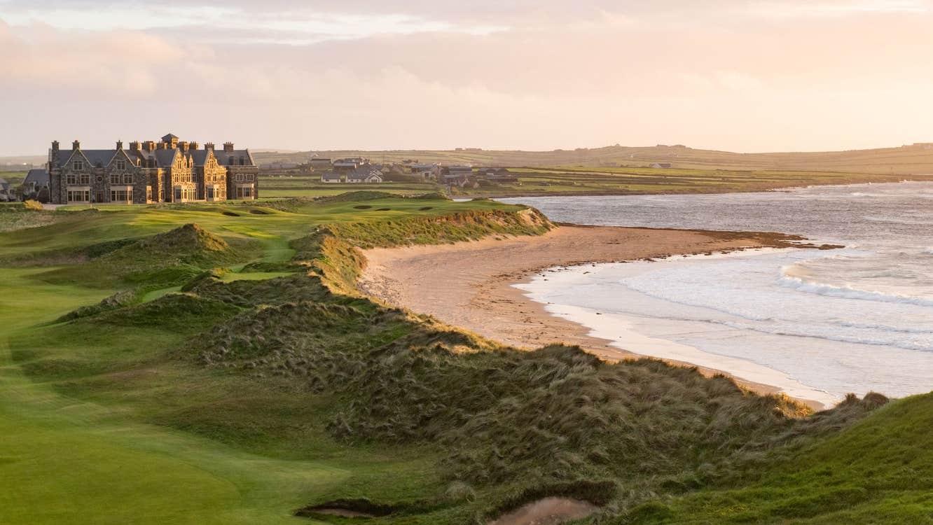 Coastal views with the Trump Doonbeg resort overlooking the beach at sunset.