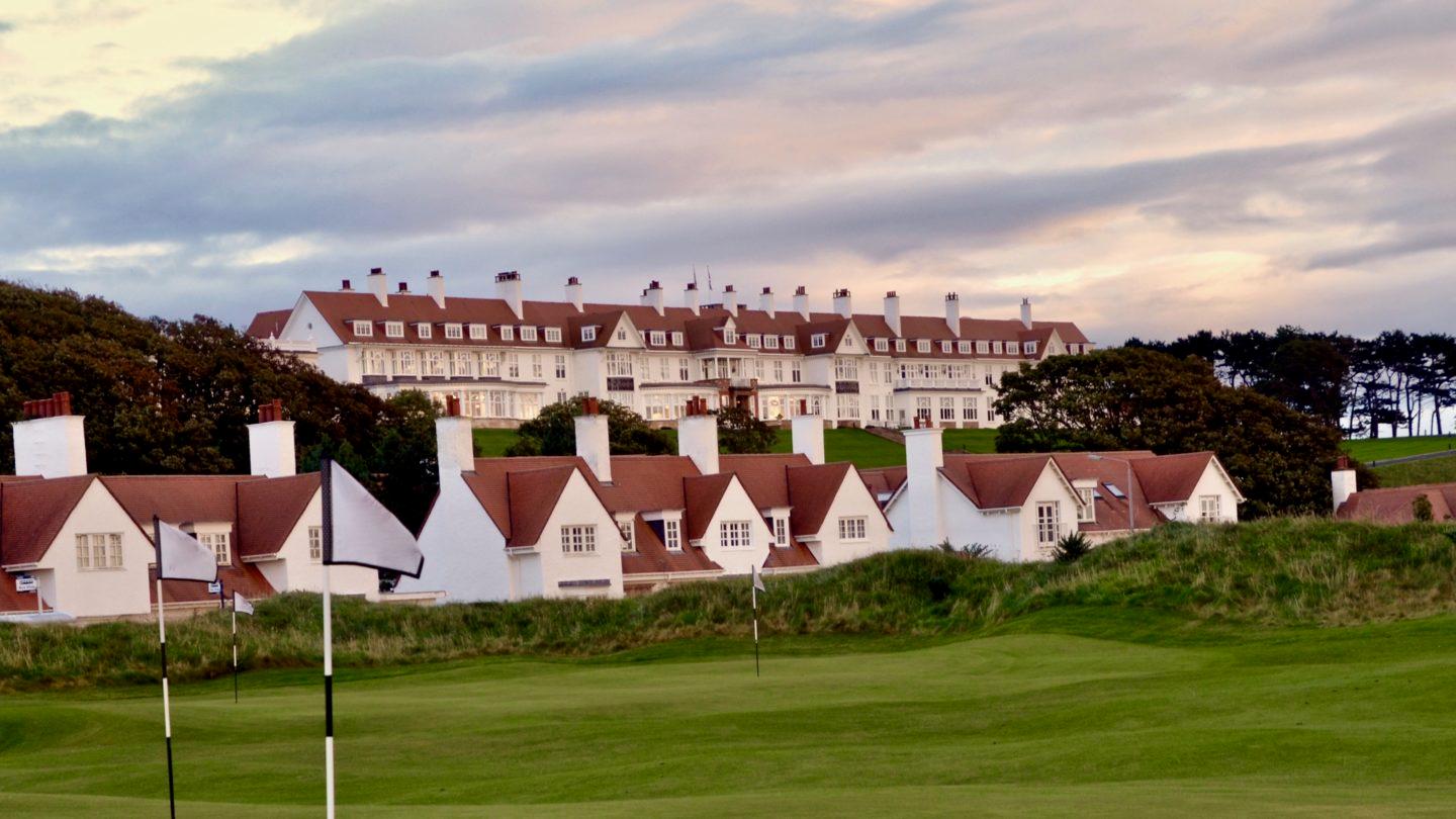 The resort and golf villas surrounded by lush green fairways and flags.