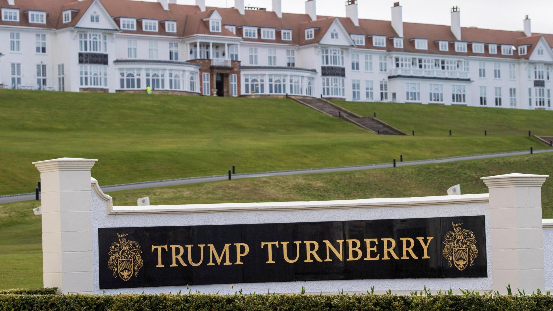 The iconic Trump Turnberry sign with the historic hotel in the background.