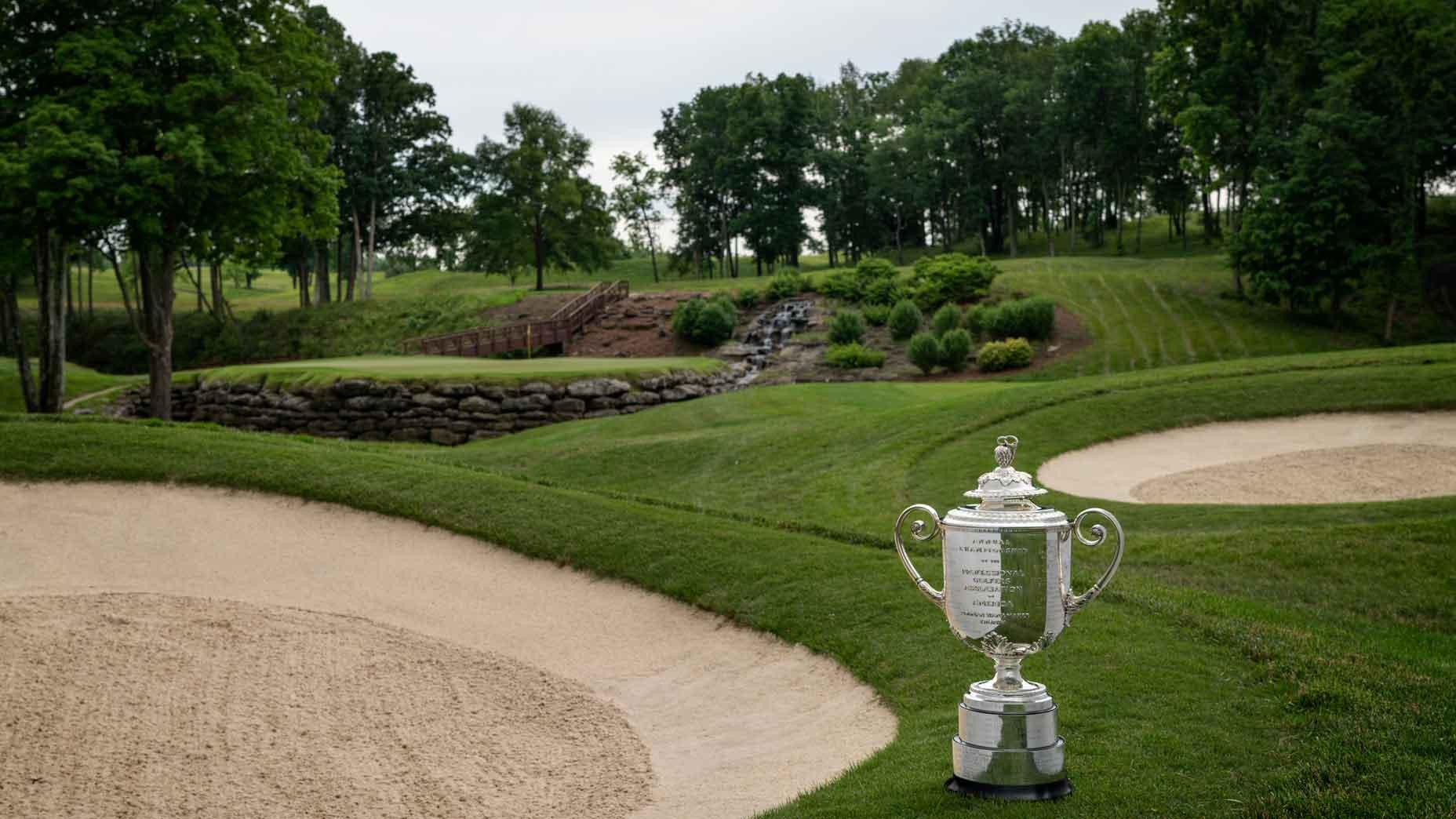 Championship cup placed next to a sand bunker at the Valhalla Course