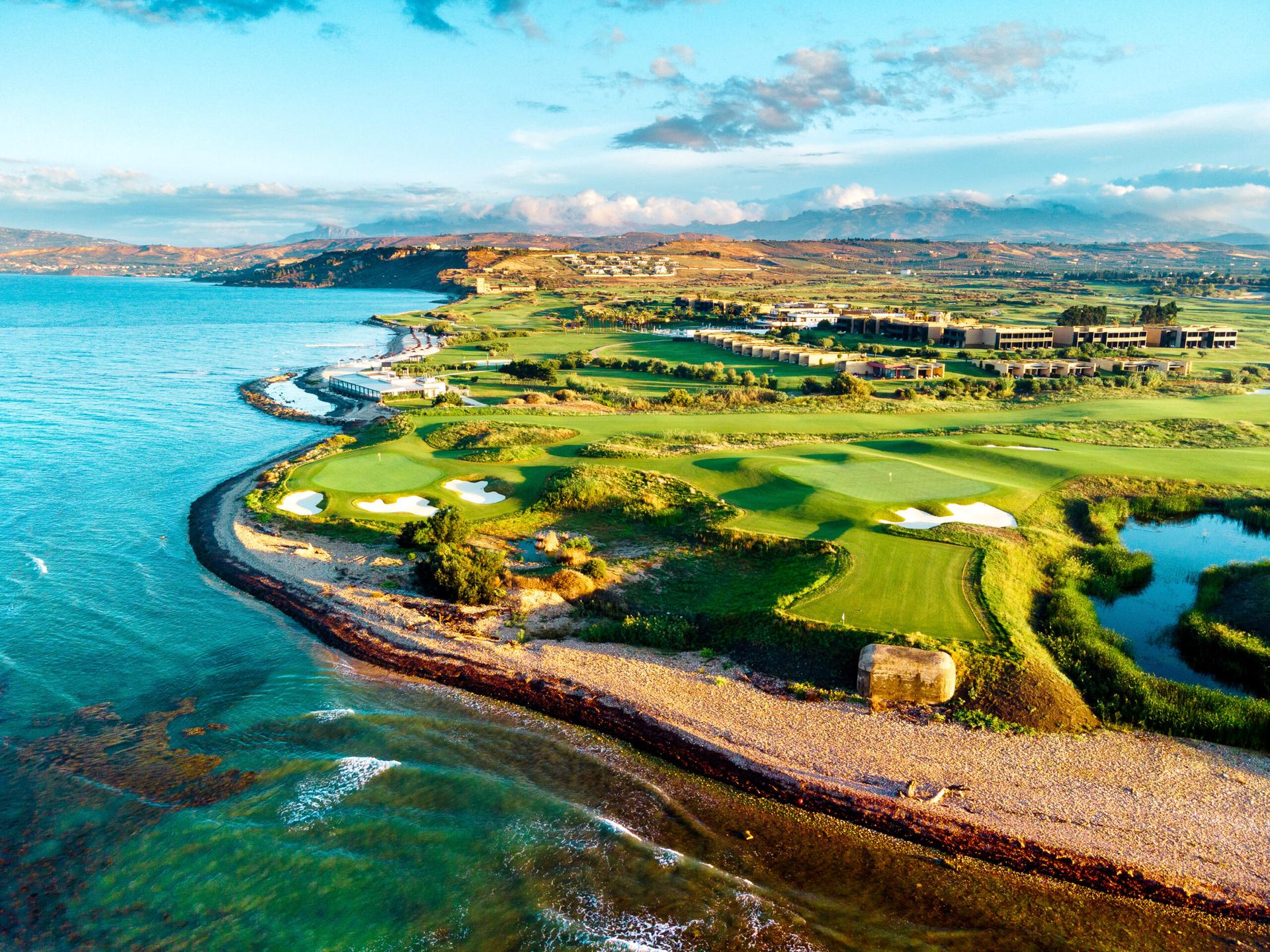 Overhead view of The Verdura Links with smooth greens, sand bunkers, and coastal views