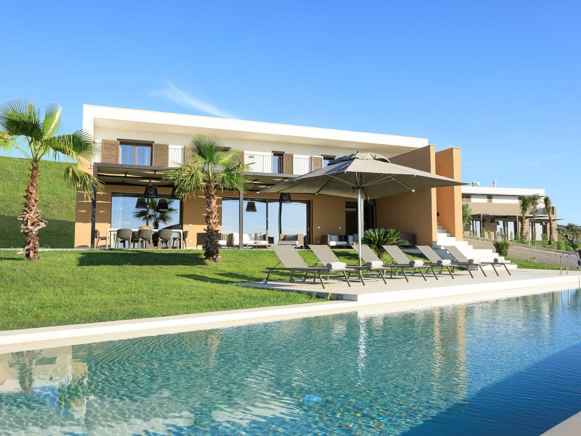A villa at the resort with an outdoor dining area alongside a personal pool