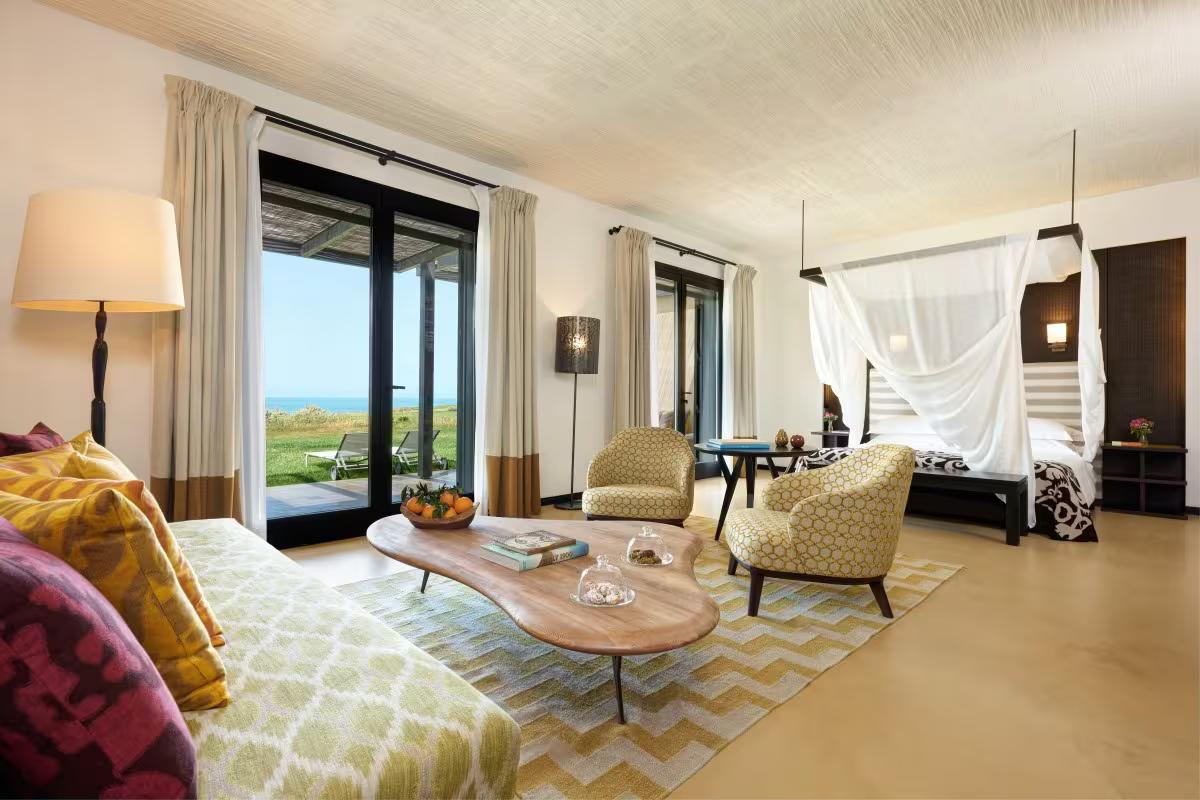 Spacious and modern double bed suite at the resort with patio views of the ocean