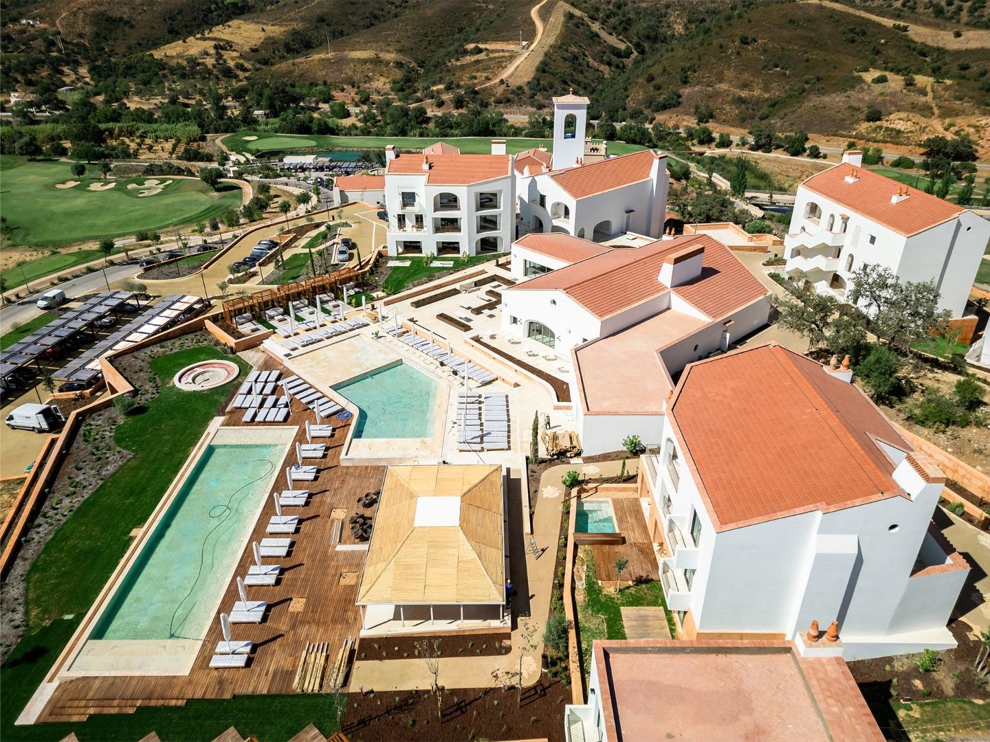 Aerial view of the hotel and swimming pools