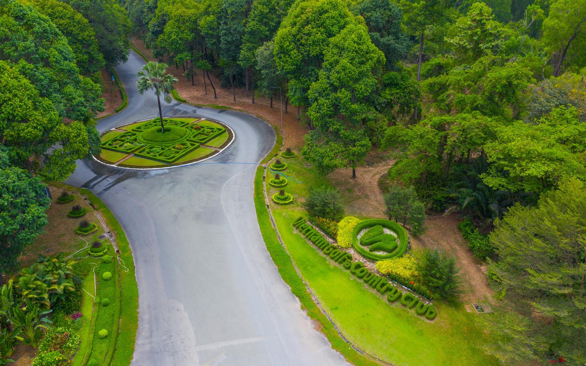 The Vietnam Golf & Country Club name sculpted into a bush at the front entrance to the course